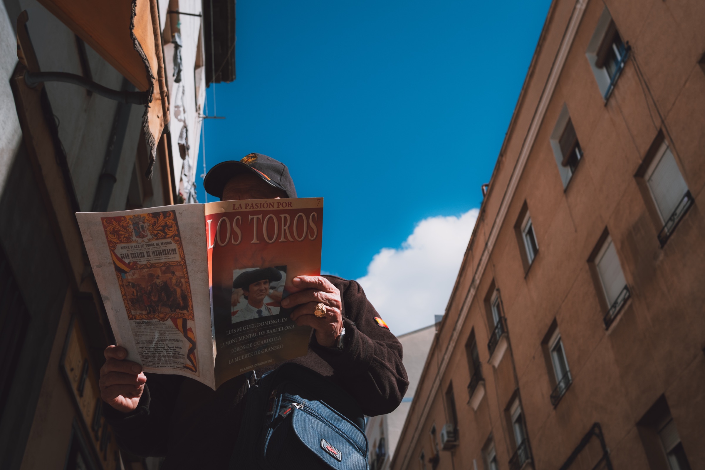 Man reading a bullfighting magazine at El Rastro market in Madrid